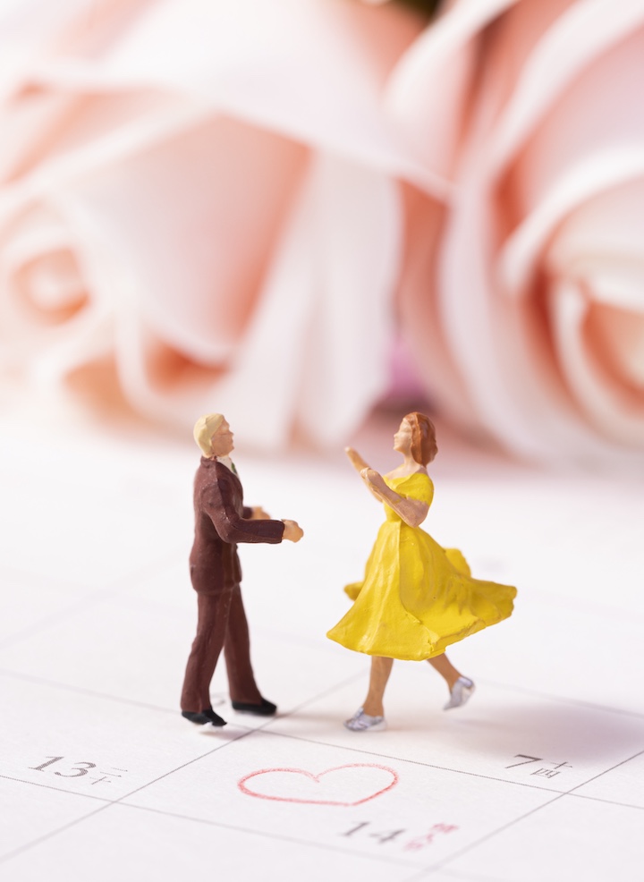 creative shot of dolls on calendar romantic - wedding planning timeline